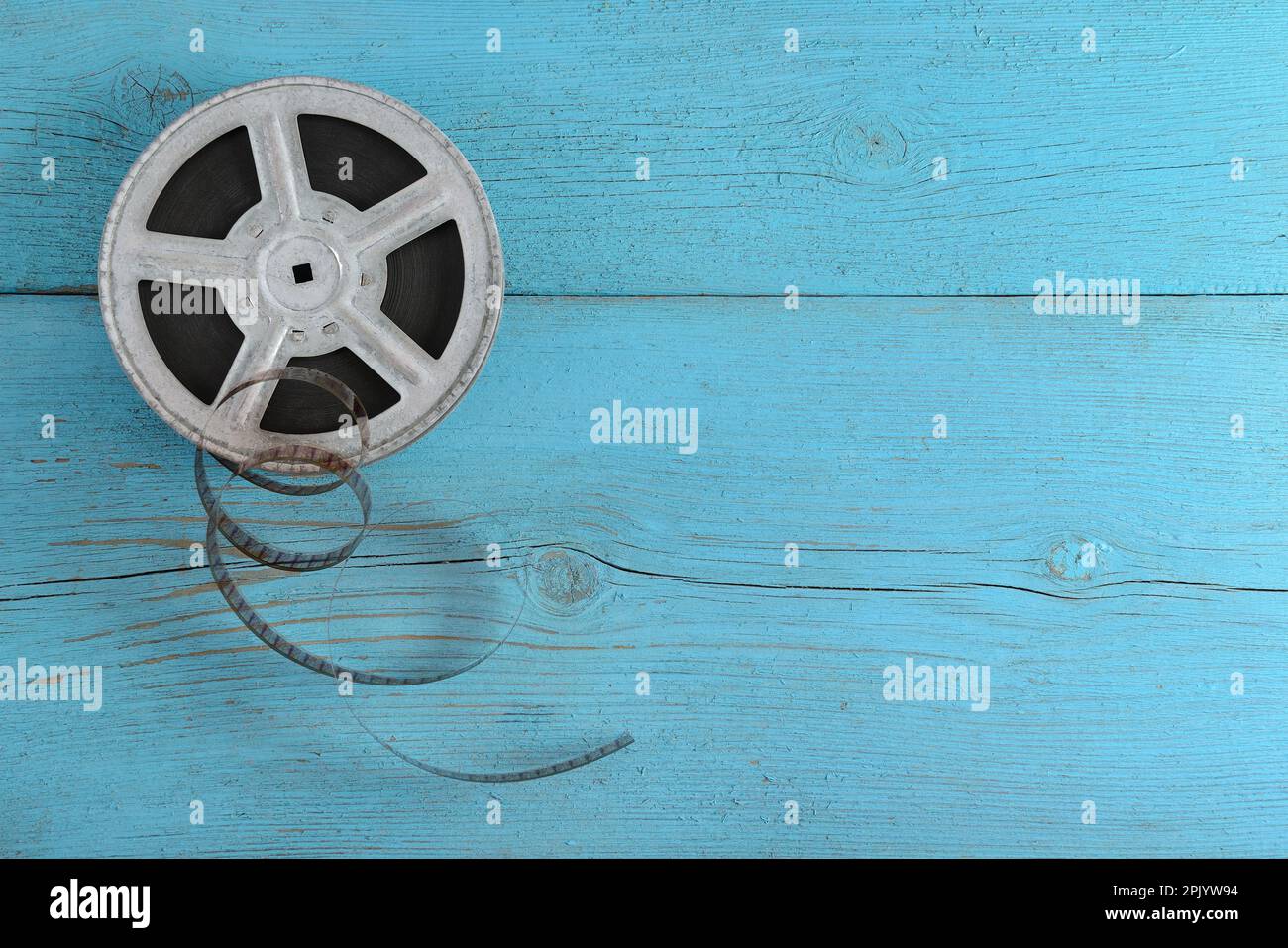 Old film strip on wooden blue background. Stock Photo