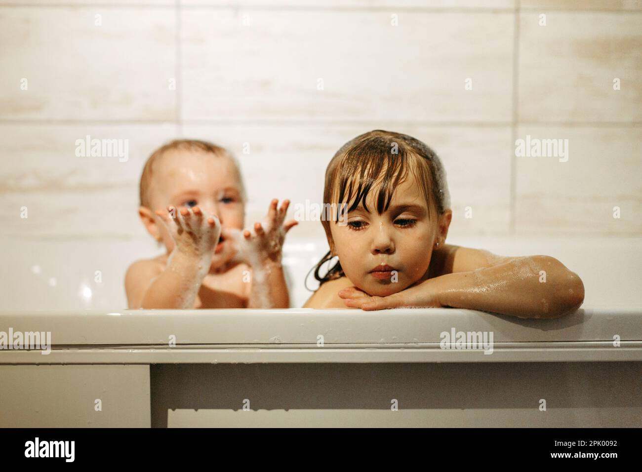 Girls sisters of preschool age are playing with foam in the bathroom Stock Photo Alamy