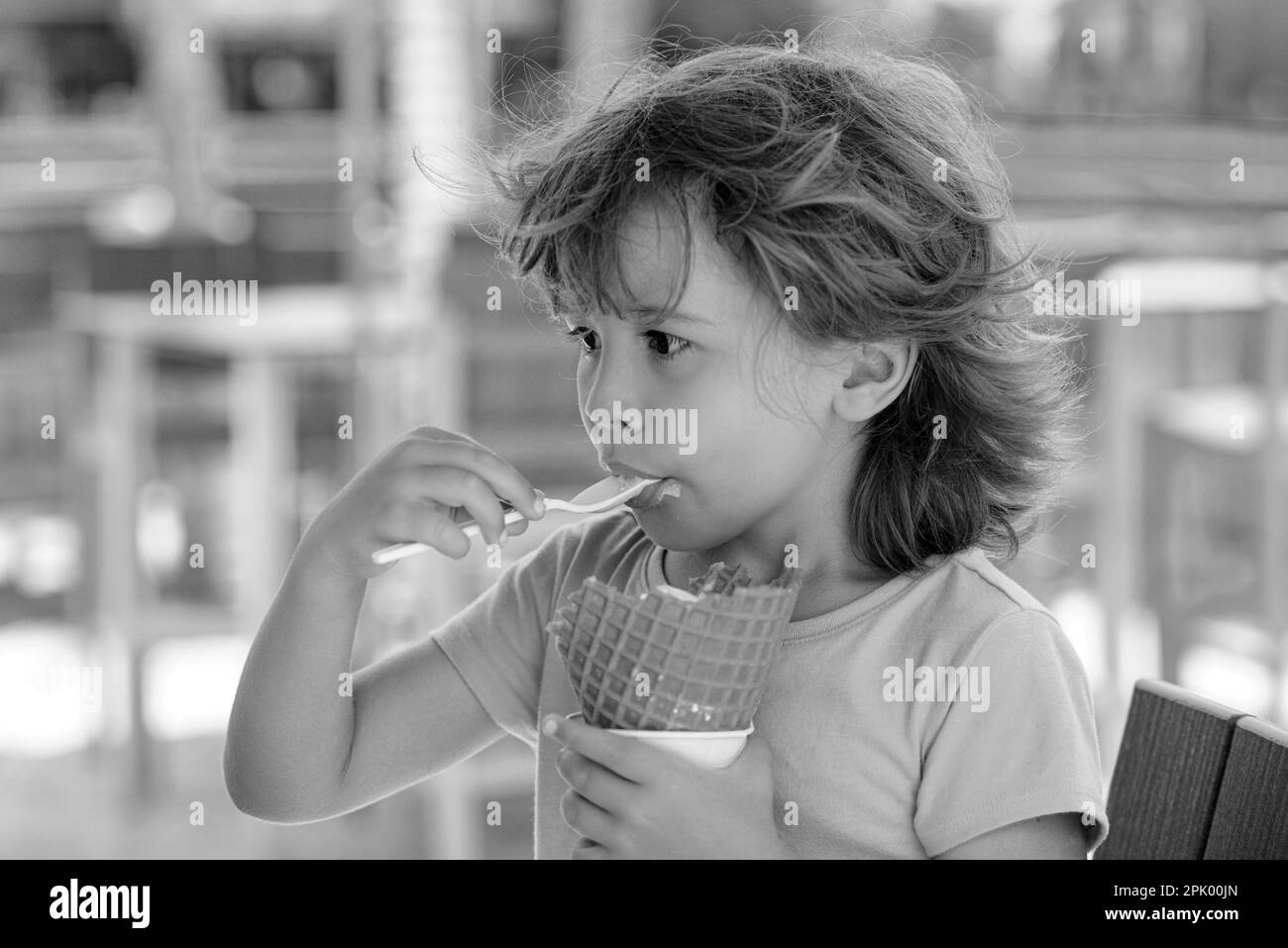 Cute child eating ice cream outdoors. Sweet summer day Stock Photo Alamy
