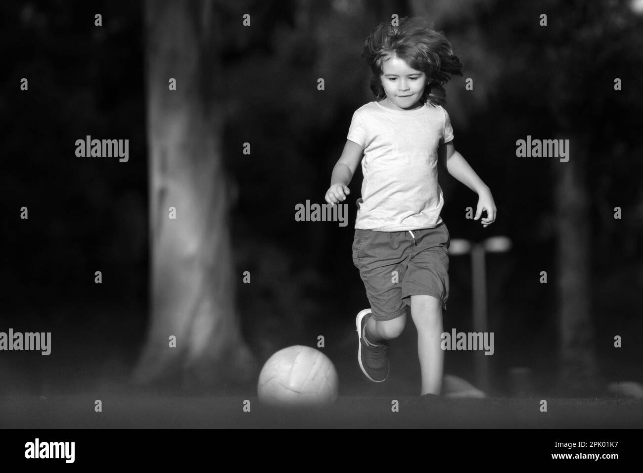 Soccer kid. Kids play football on outdoor stadium field. Little boy
