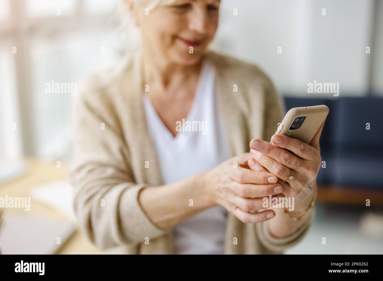 Smiling senior woman using smartphone Stock Photo