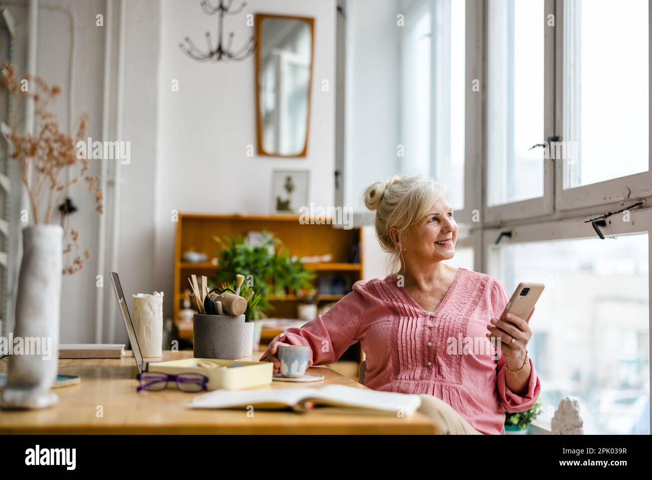 Smiling senior woman using smartphone Stock Photo