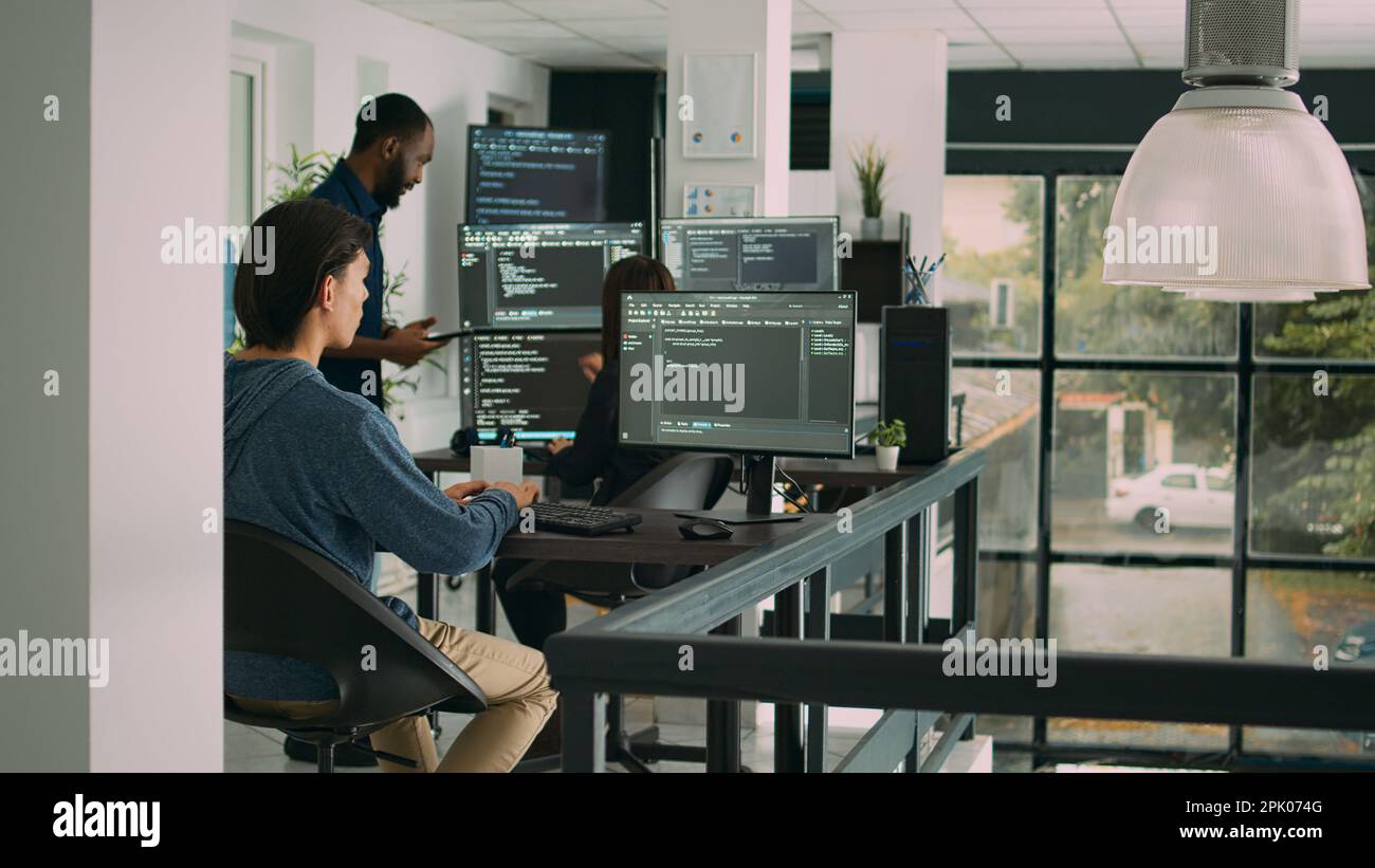Male software developer typing machine learning app code on computer, sitting at desk in big data office. Cloud programer working on database system with html script in it security agency. Stock Photo
