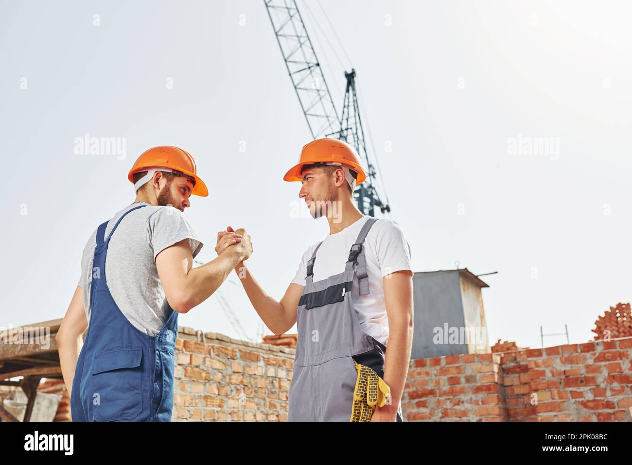 Construction workers in orange uniforms hi-res stock photography and ...