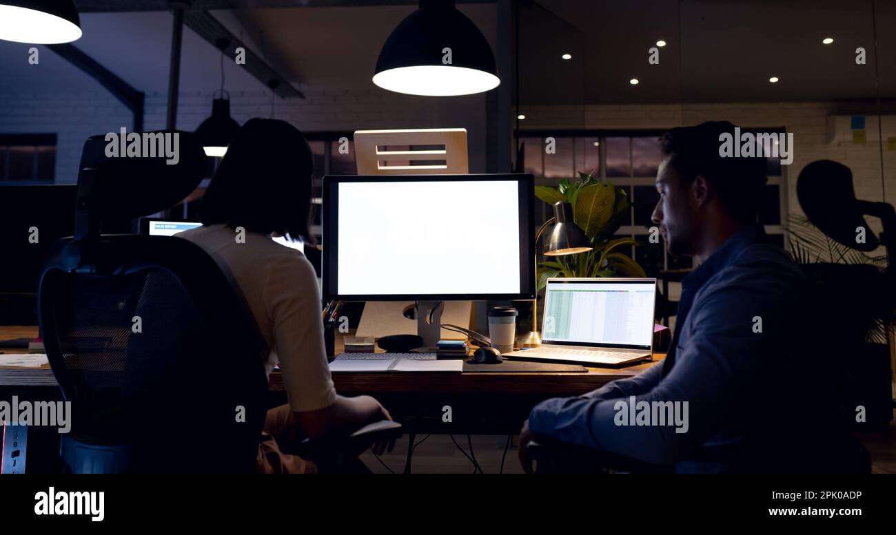 Diverse business people at desk, using computers with copy space on ...