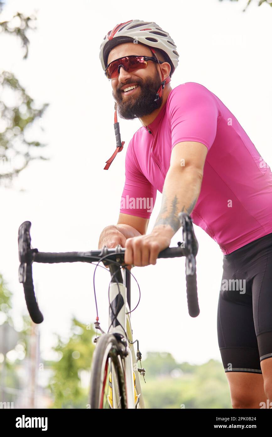 Strong Male cyclist in sportswear glasses and protective helmet