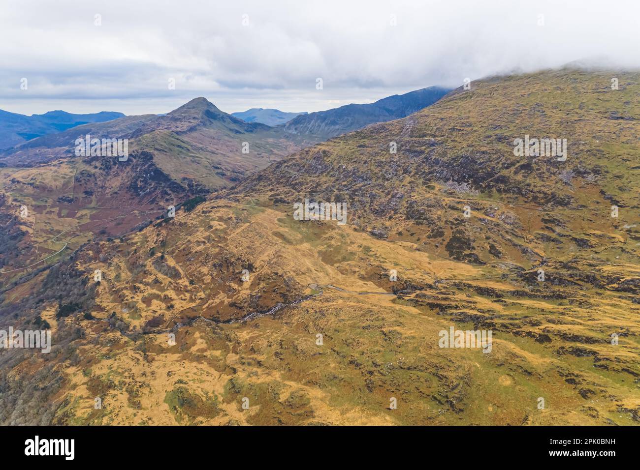 Stunning part of Snowdonia National Park, Wales seen from aerial view perspective. Cloudy sky over mountain range. High quality photo Stock Photo