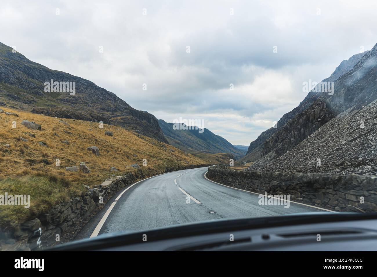Landscape of Snowdonia National Park seen through car front window. Eryri Wales' largest