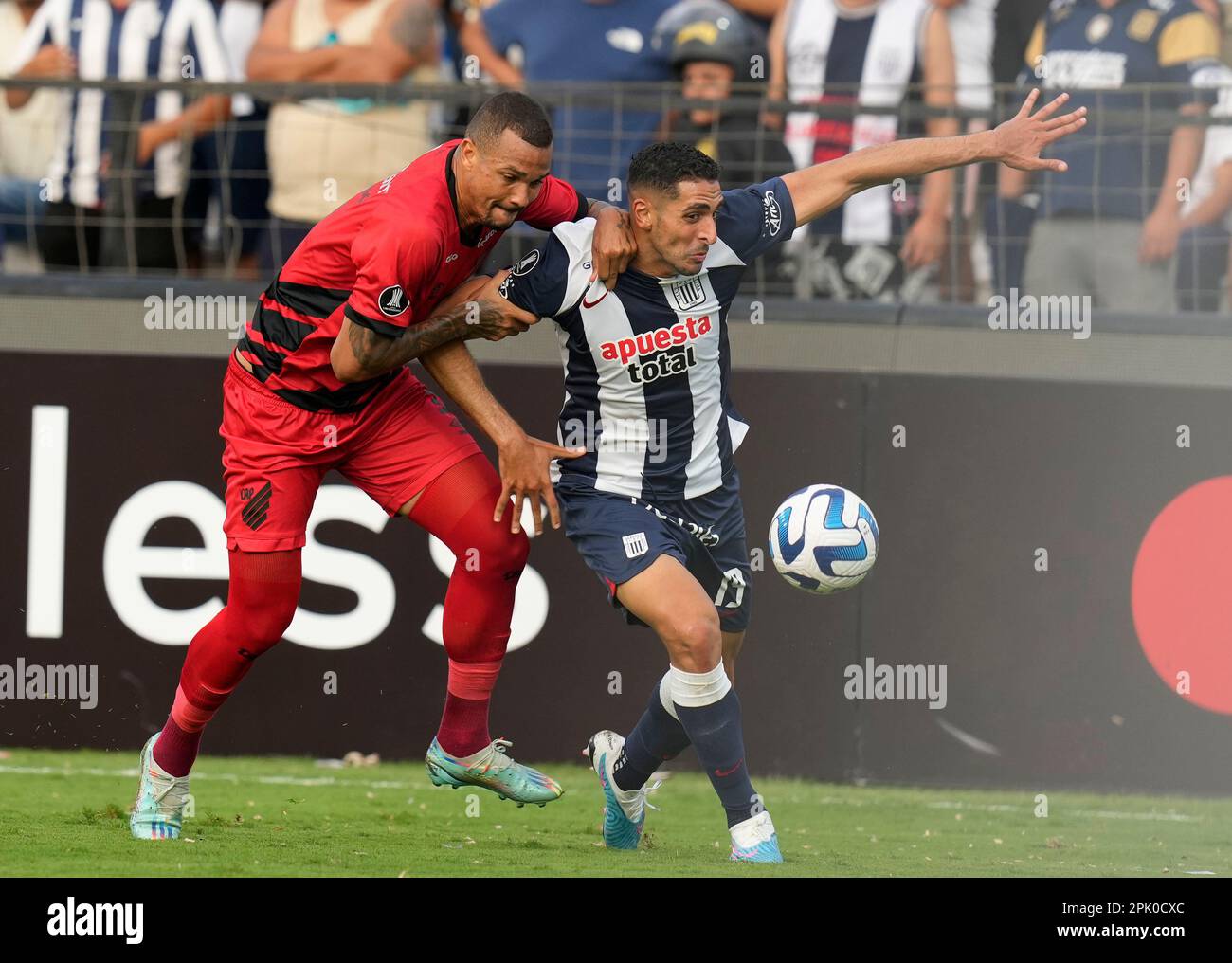 Ze Ivaldo of Brazil's Athletico Paranaense heads the ball in an attempt to  score as Diego Viera of Paraguay's Libertad challenges him during a Copa  Libertadores round of sixteen second leg soccer