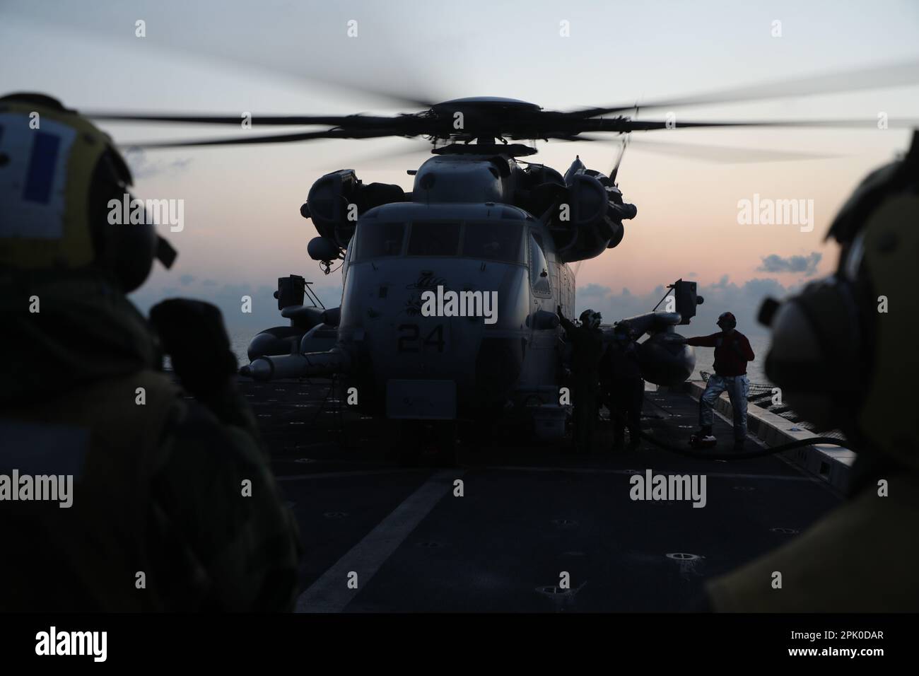 South China Sea (March. 21, 2023) – U.S. Marines assigned to Marine Medium Tiltrotor Squadron (VMM) 362 (Reinforced), 13th Marine Expeditionary Unit, and Sailors assigned to the amphibious transport dock USS John P. Murtha (LPD 26) prepare a CH-53E Super Stallion for take-off aboard the John P. Murtha, March 21. The mobility and sustainability provided by amphibious platforms like the CH-53E Super Stallion enable the Navy-Marine Corps team to extend the reach of our capabilities. The 13th MEU is embarked with the Makin Island Amphibious Ready Group, comprised of the amphibious assault ship USS Stock Photo