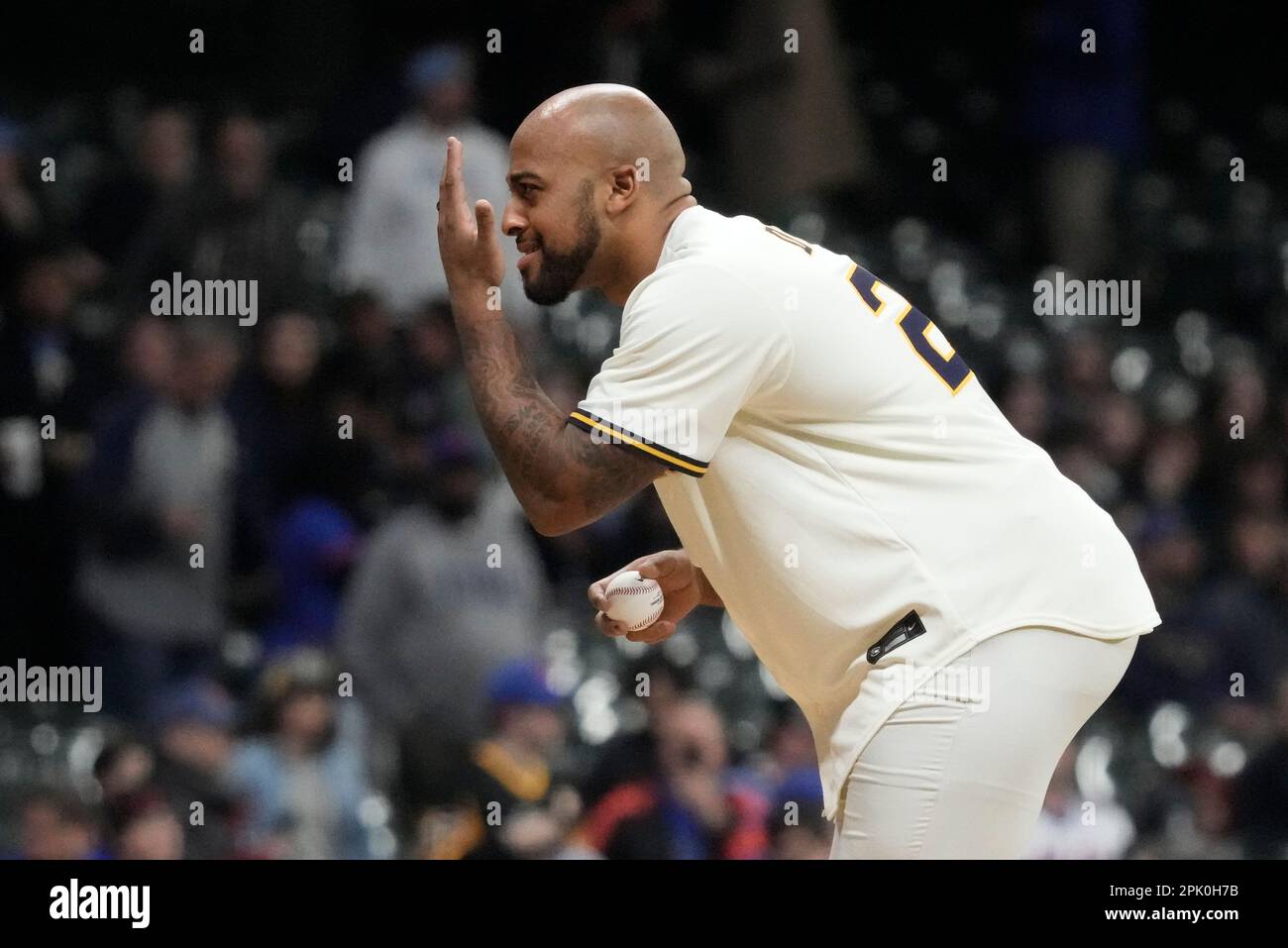 Green Bay Packers' A.J. Dillon throws out the ceremonial first pitch before  a baseball game between the Milwaukee Brewers and the New York Mets  Tuesday, April 4, 2023, in Milwaukee. (AP Photo/Morry