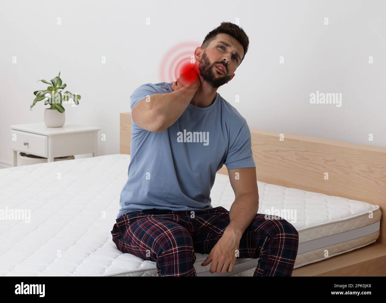 Man suffering from neck pain after sleeping on mattress