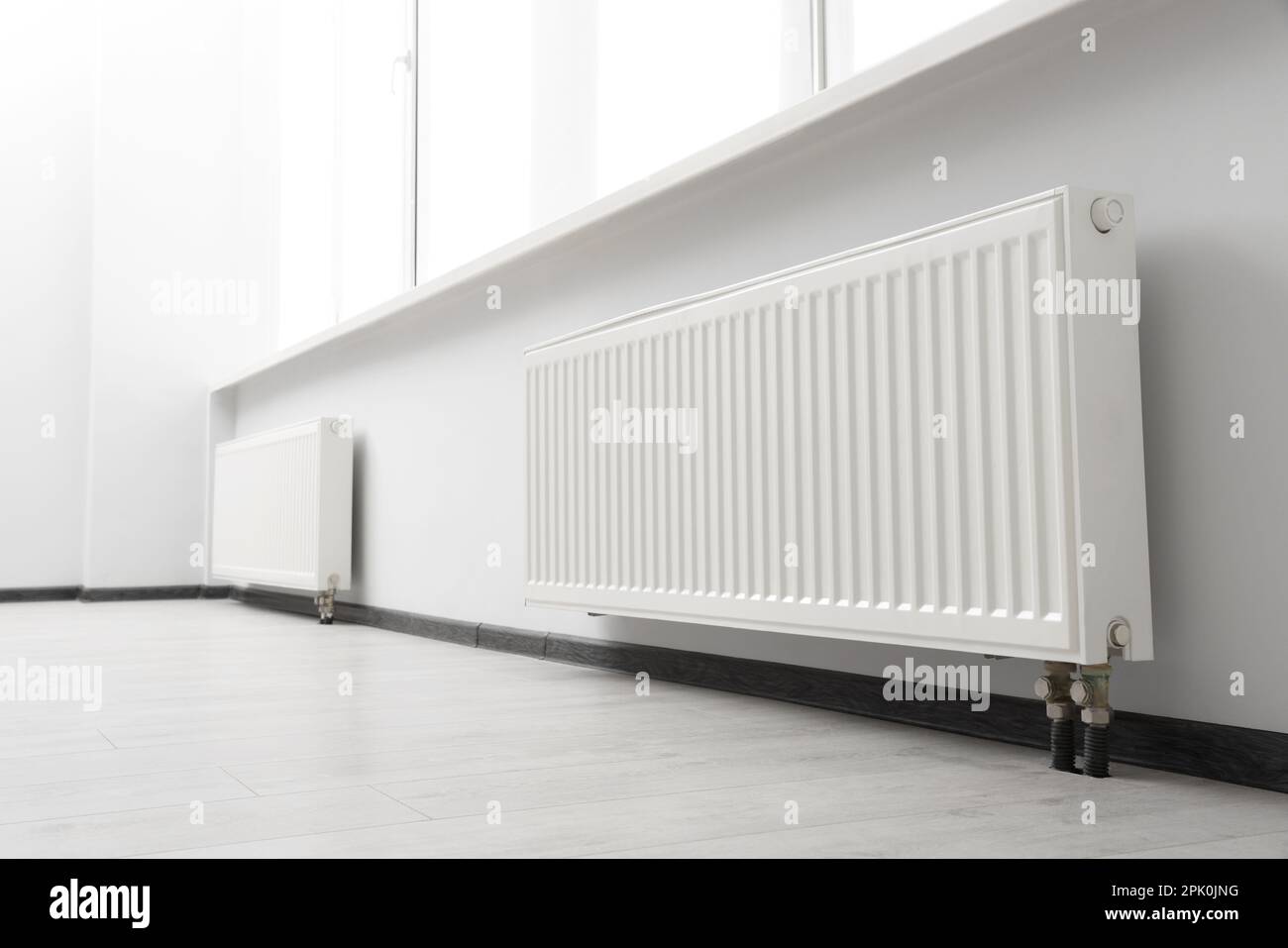 Modern radiators in room. Central heating system Stock Photo Alamy