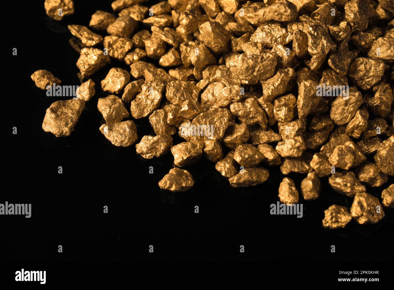 Pile of gold nuggets on black background, closeup Stock Photo - Alamy
