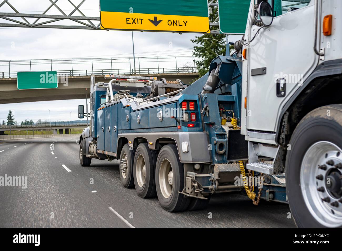 Powerful blue big rig heavy duty towing semi truck tractor with lifting