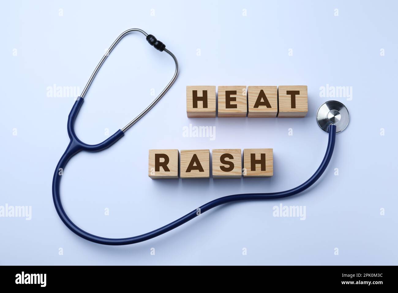 Wooden cubes with words Heat Rash and stethoscope on white background