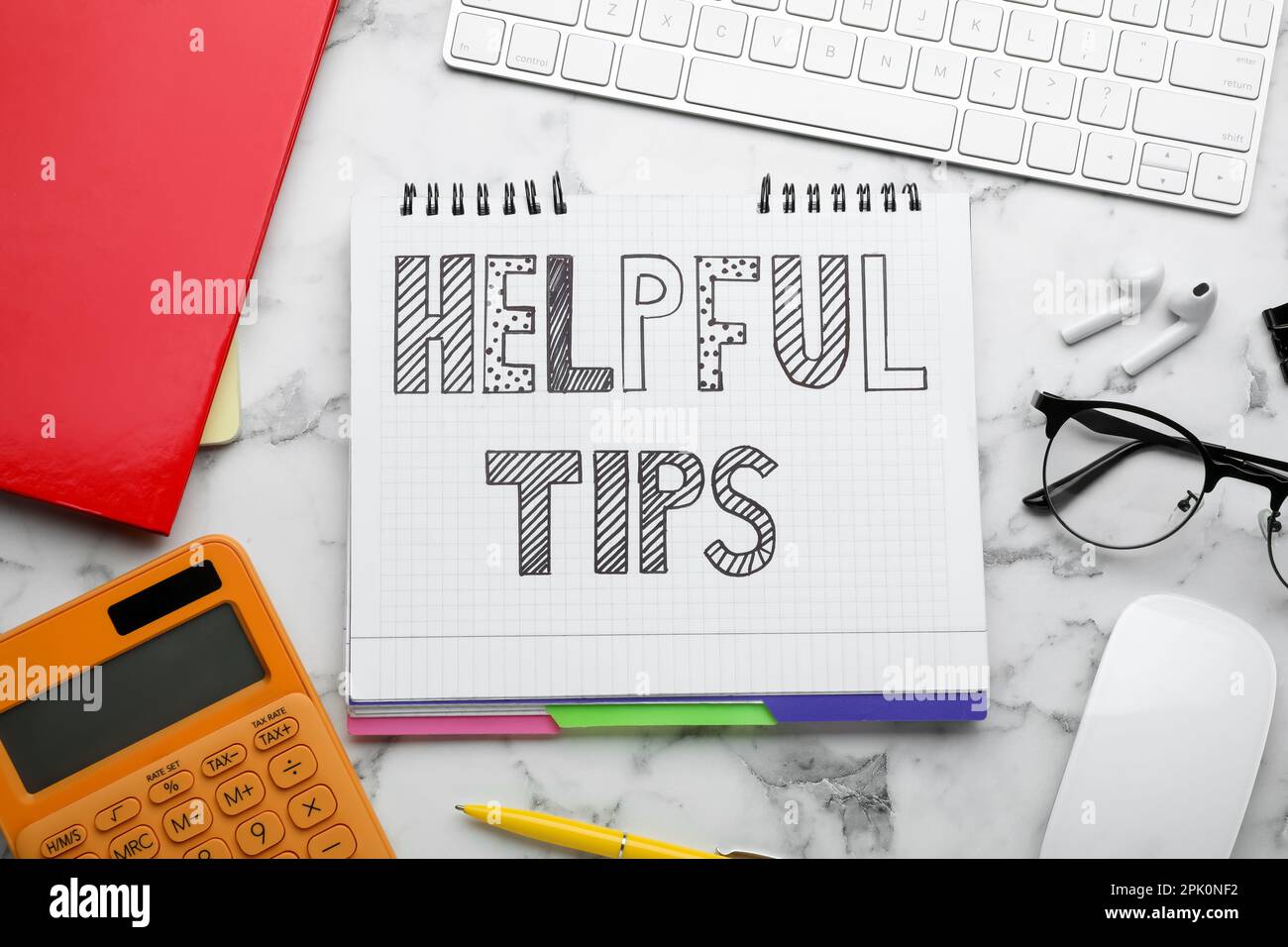 Flat lay composition with text Helpful Tips in notebook on white marble table Stock Photo