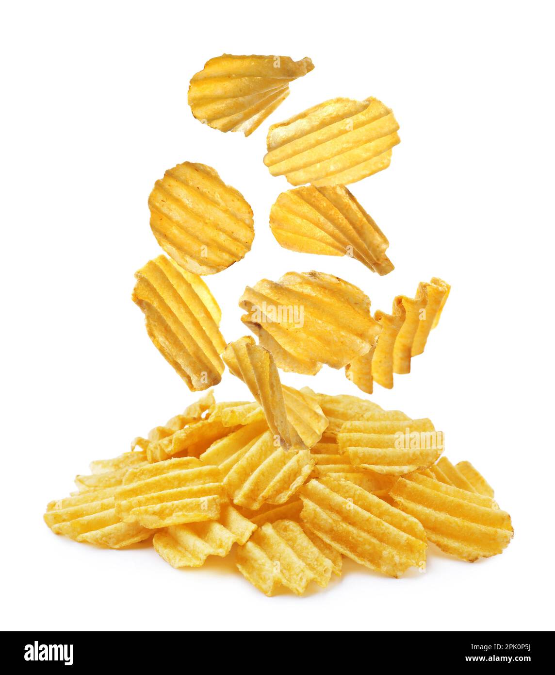 Ridged crispy potato chips falling into heap on white background Stock Photo