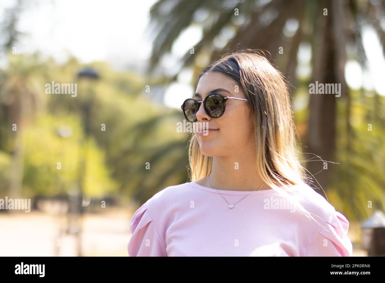 Teen girl with glasses enjoying her morning off in the park Stock Photo