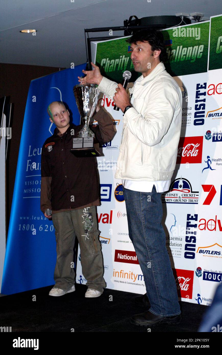 NRL footballer Laurie Daly with leukemia sufferer Anthony Benton at the Charity Media Challenge, in which teams from leading media organizations compete in touch football matches to raise funds for leukemia research.   $115,000 was raised on the day, bringing the total funds raised to $350,000 in the three years that the annual event has been held.  The Grand Final game was held between the teams from Fox Sports and News Limited, with Fox Sports winning the game with a full-time score of 3 to 1. Sydney Football Stadium, Sydney, Australia. 19.08.07. Stock Photo