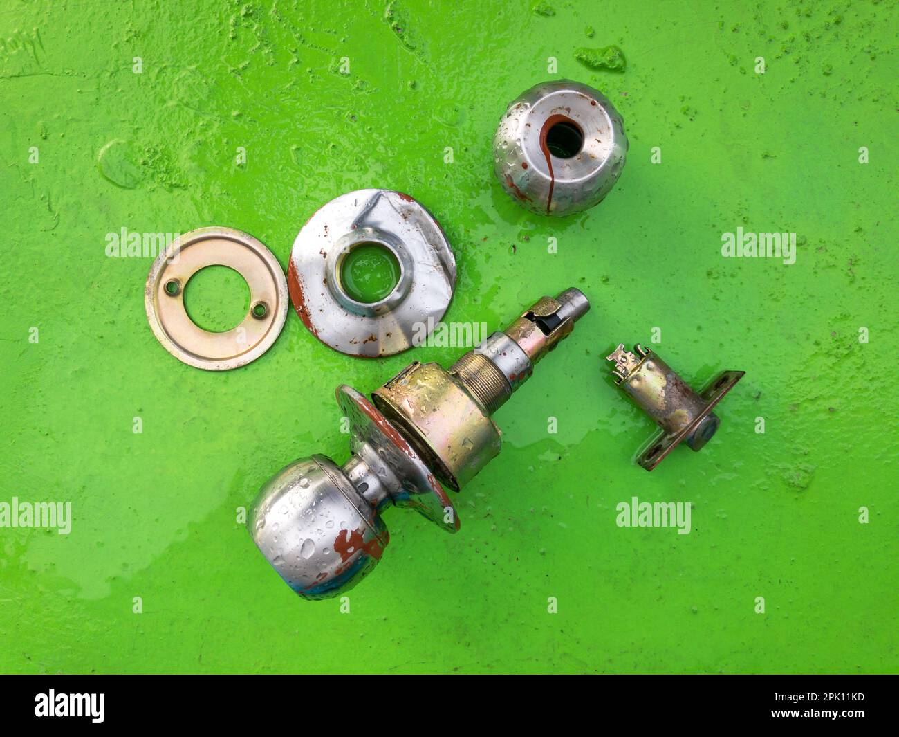 Broken door knob isolated on a green background Stock Photo