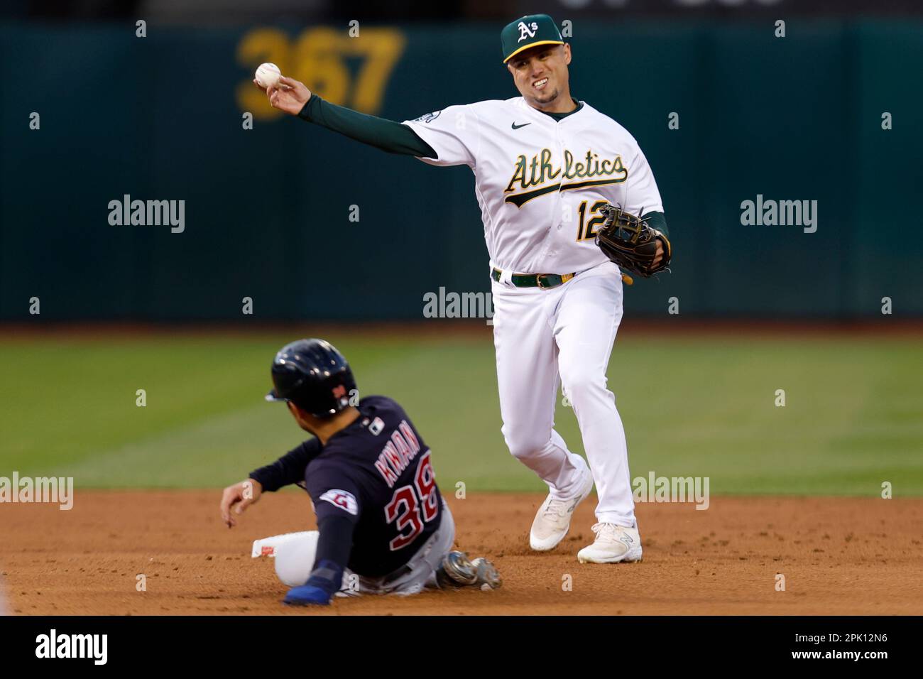 Oakland Athletics shortstop Aledmys Diaz (12) throws to first as Cleveland  Guardians' Steven Kwan (38) slides into second on a double play hit into by  Jose Ramirez during the third inning of