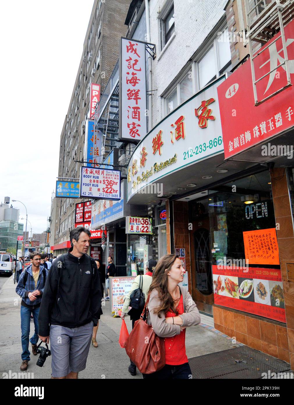 Walking on Bowery street in Chinatown in Manhattan, New York City, NY, USA. Stock Photo