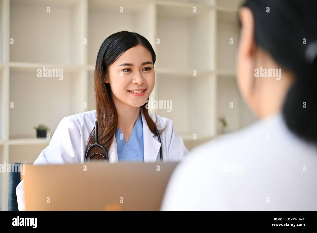 Professional and kind millennial Asian female doctor consults on a