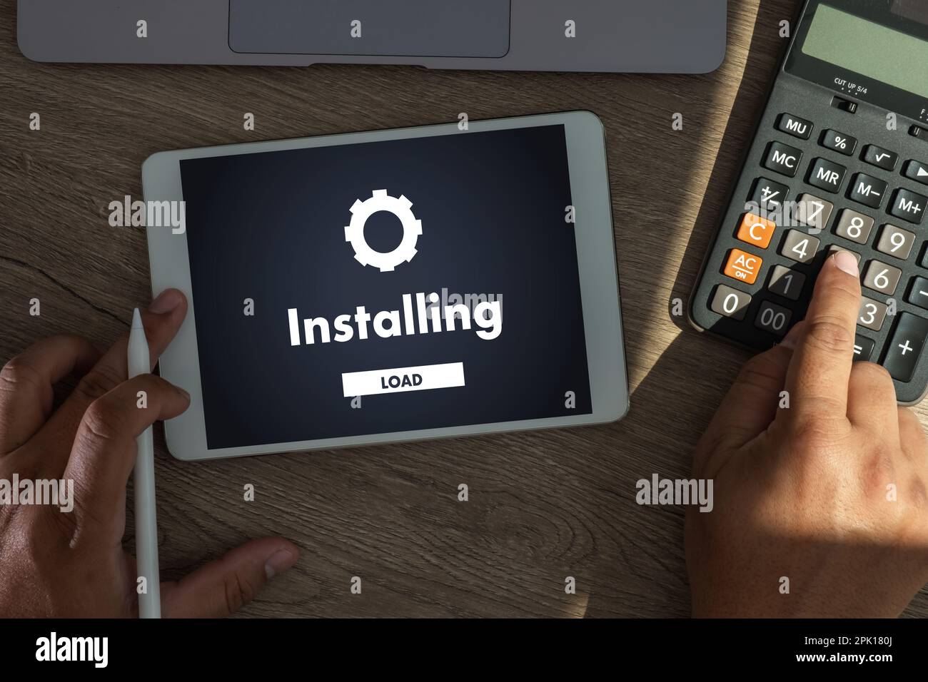 man installing Software Update On Mobile Phone And Laptop digital technology communication Stock Photo