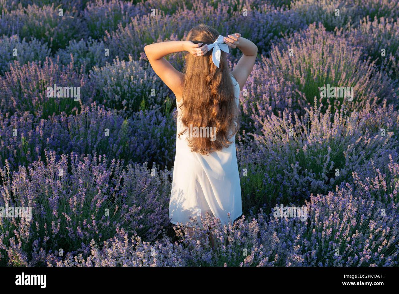 teen girl in lavender flowers with long hair outdoor. teen girl in ...