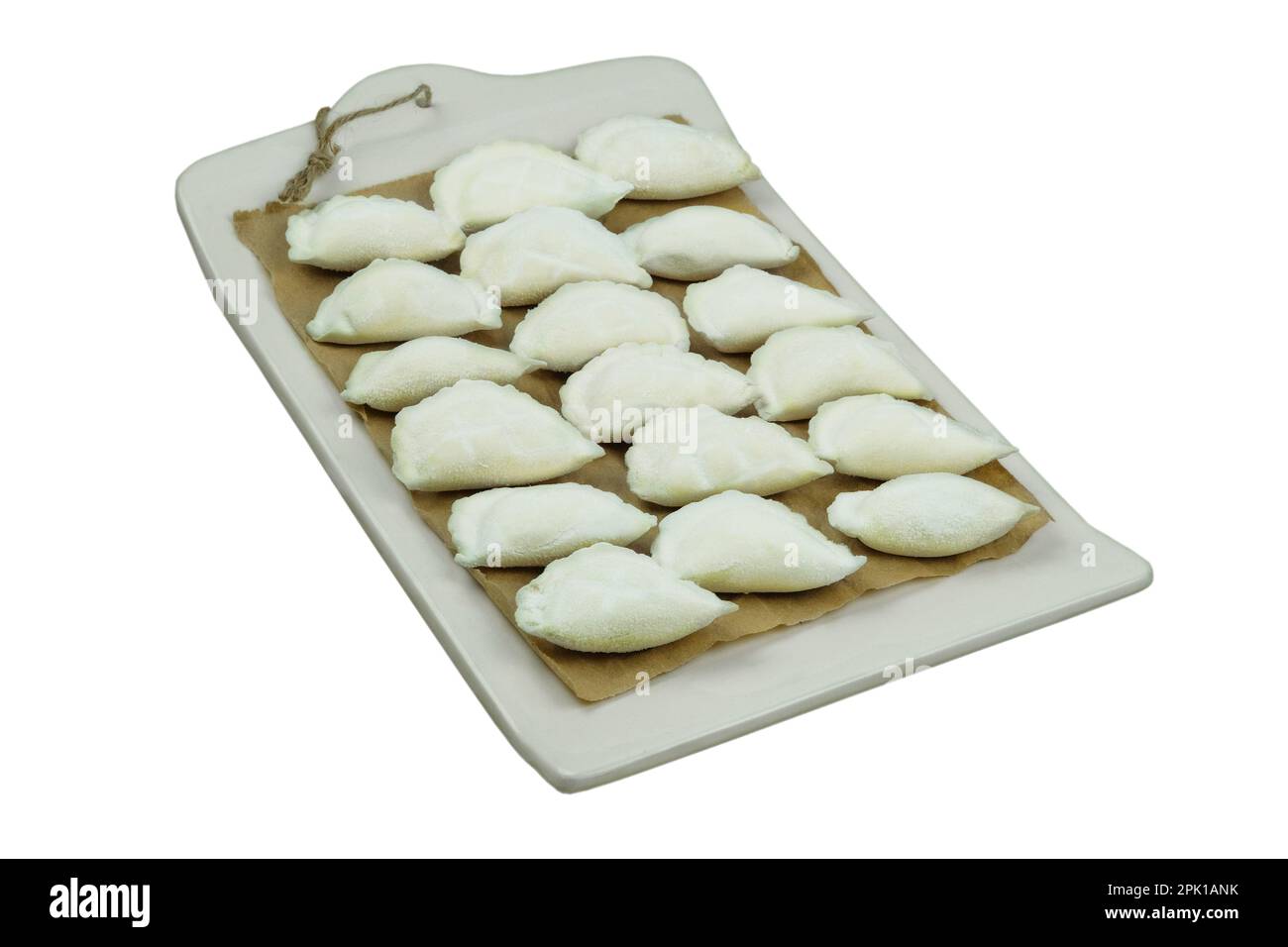 Varenik before cooking board on a white background. Ukrainian cuisine. Fast food. Home cooking. Stock Photo