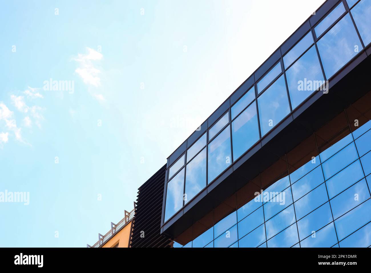 Low angle view of modern building with tinted windows against blue sky Stock Photo