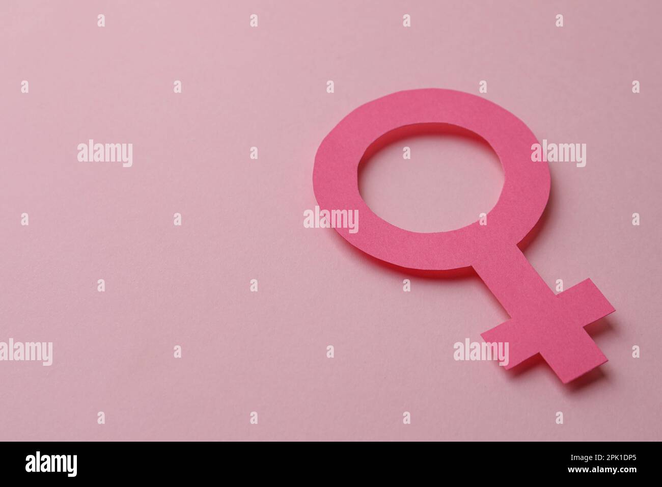 Female gender sign and space for text on pink background Stock Photo