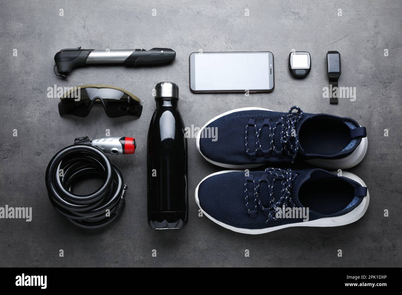 Flat lay composition with different cycling accessories on grey background Stock Photo