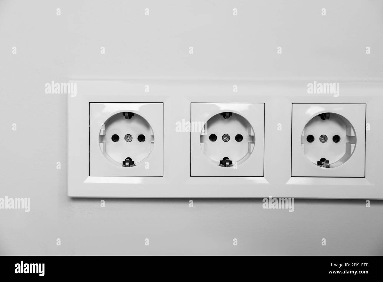 Power sockets on white wall. Electrical supply Stock Photo Alamy