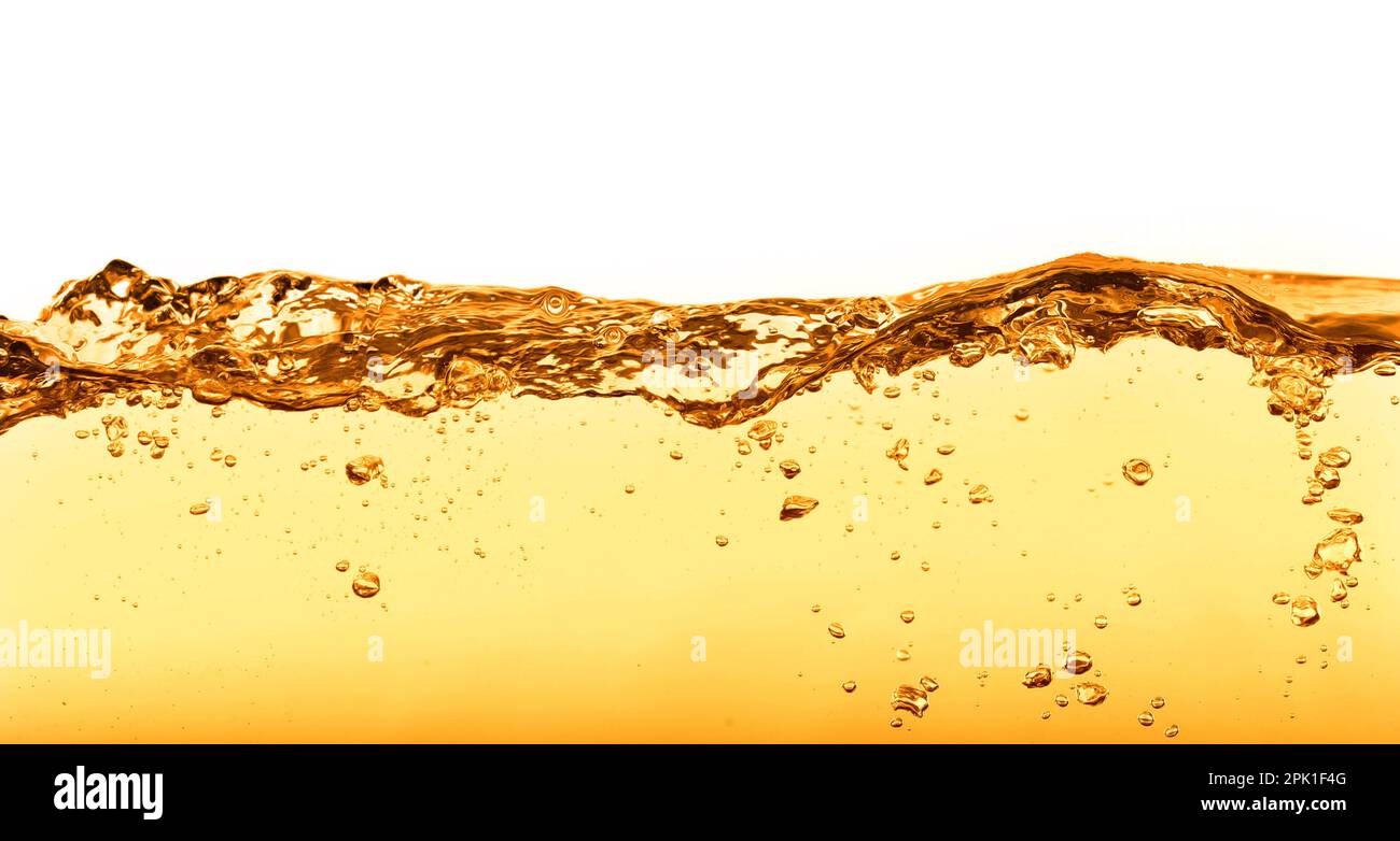 Golden oily liquid splash on white background Stock Photo - Alamy