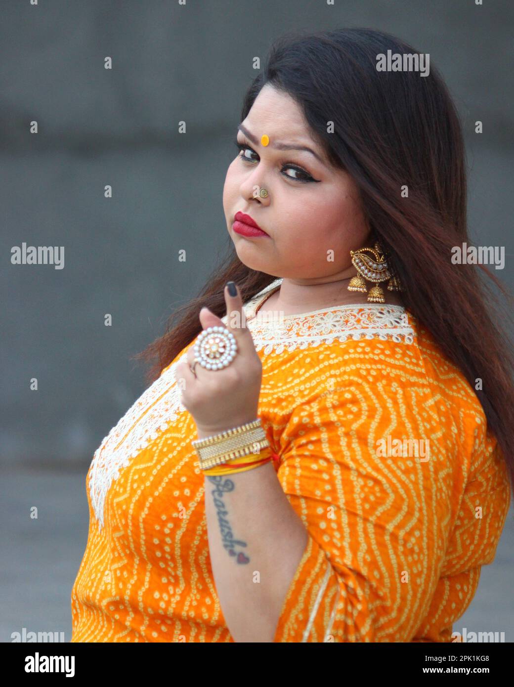 A Lady Don is warning in an anger. Plus Size model. Indian Outfit
