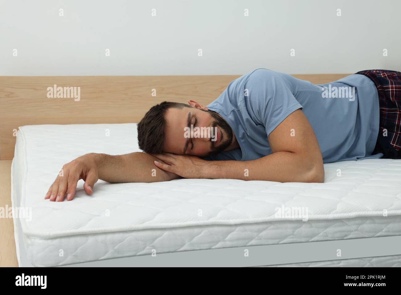 Man sleeping on bed with comfortable mattress at home Stock Photo Alamy