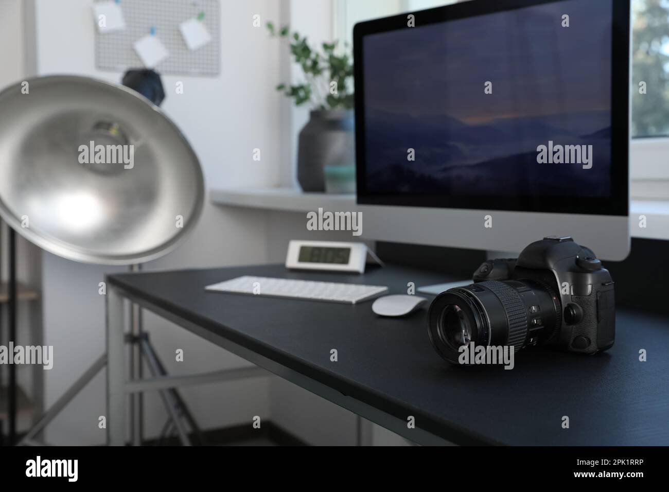 Professional camera and computer on table in photo studio. Interior ...