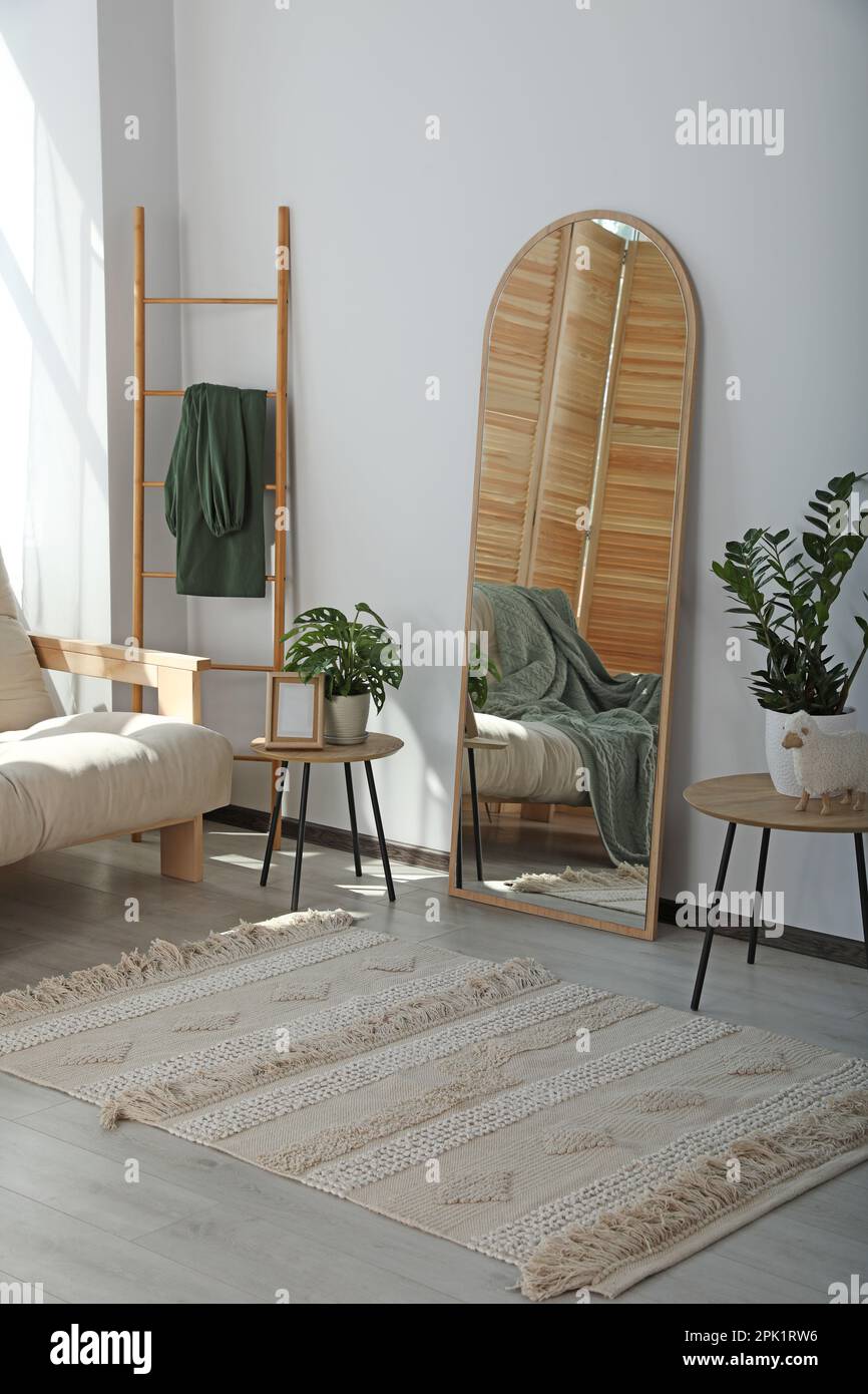 Stylish room interior with leaning floor mirror Stock Photo Alamy