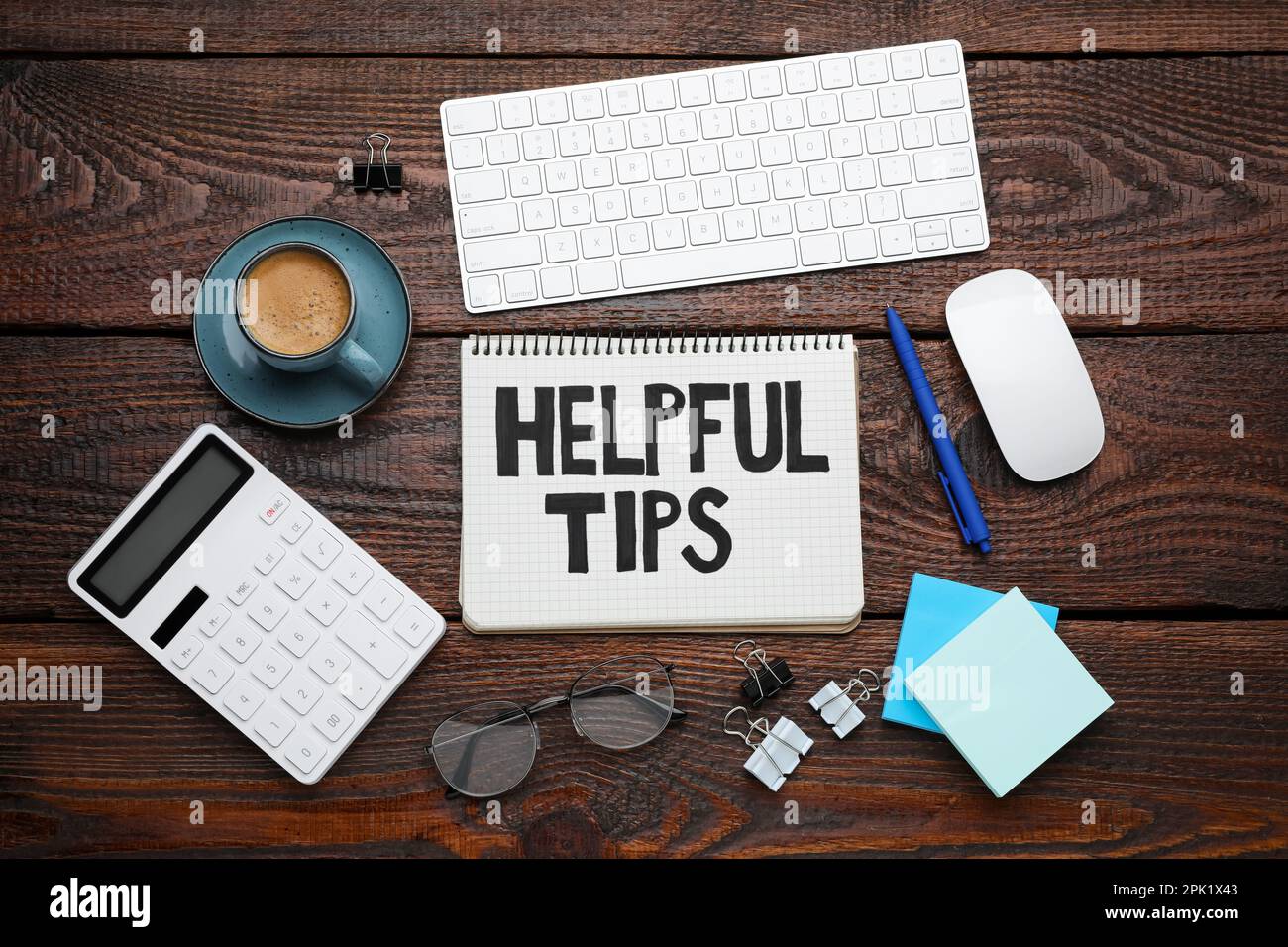 Flat lay composition with text Helpful Tips in notebook on wooden table Stock Photo