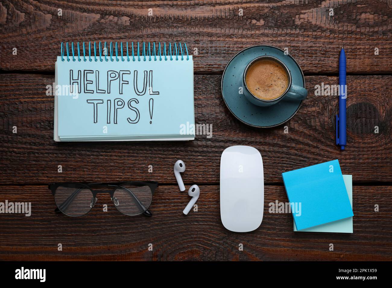 Flat lay composition with text Helpful Tips in notebook on wooden table Stock Photo