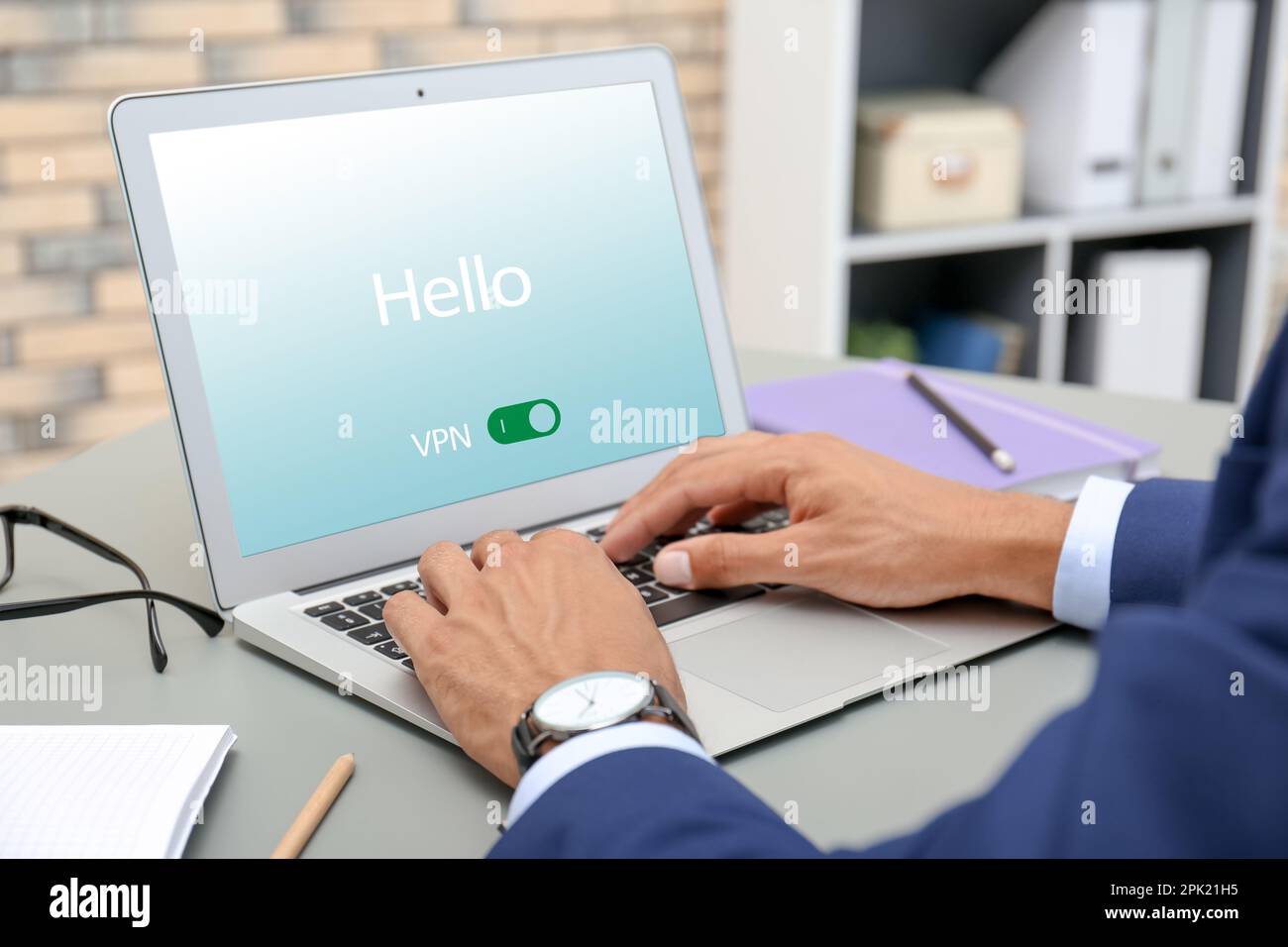 Man using laptop with switched on VPN at table, closeup Stock Photo