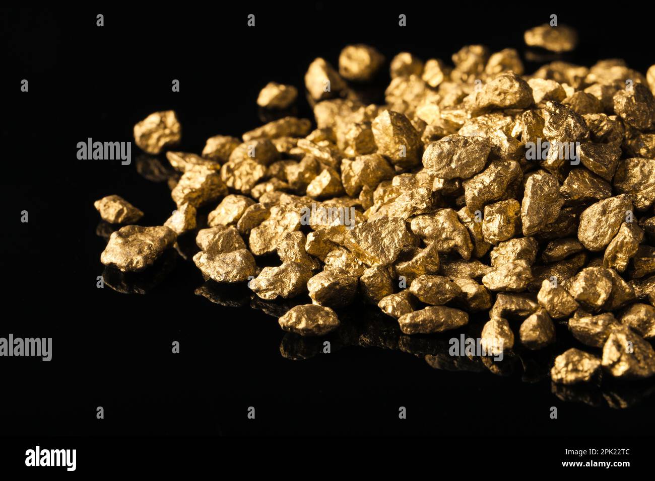 Pile of gold nuggets on black background, closeup Stock Photo - Alamy