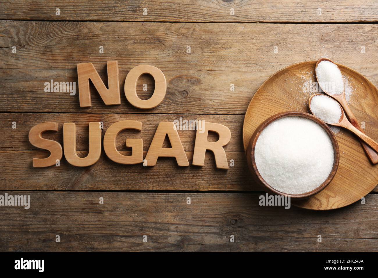 Flat lay composition with phrase No Sugar on wooden table Stock Photo