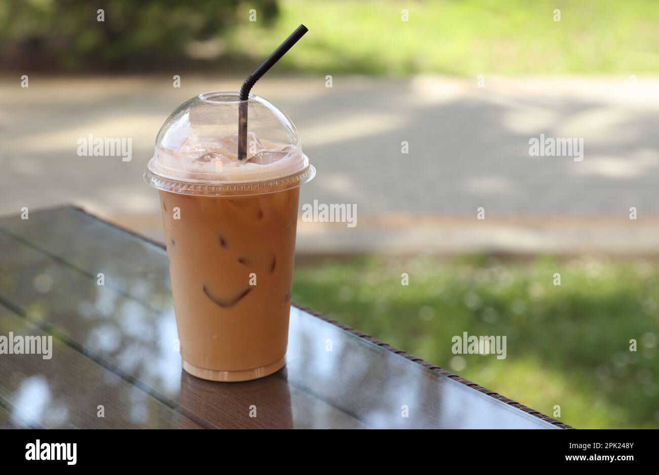 Fresh coffee, iced cappuccino, Macchiato, latte with separate milk and  coffee. Coffee in a plastic cup on a wooden table. plastic iced coffee mug  on wooden table 9501159 Stock Photo at Vecteezy