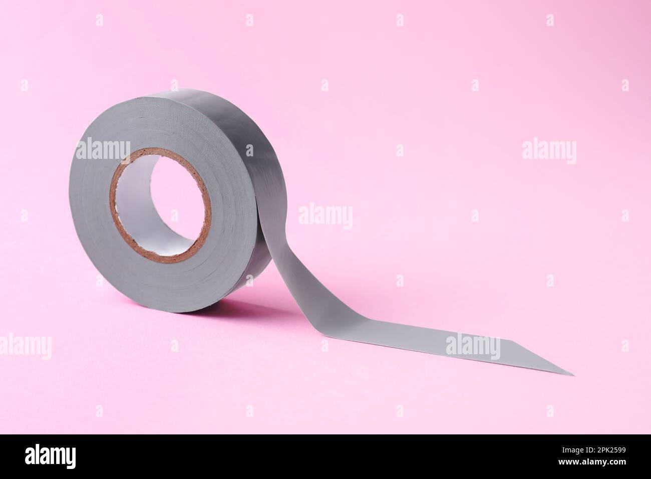 Grey insulating tape on pink background. Space for text Stock Photo