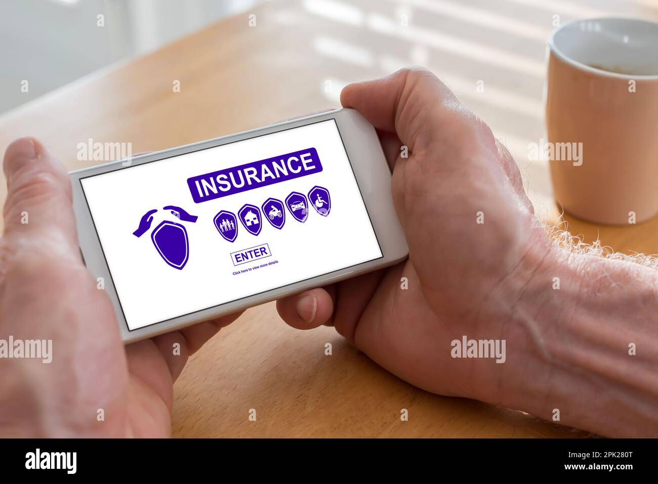 Male hands holding a smartphone with insurance concept Stock Photo