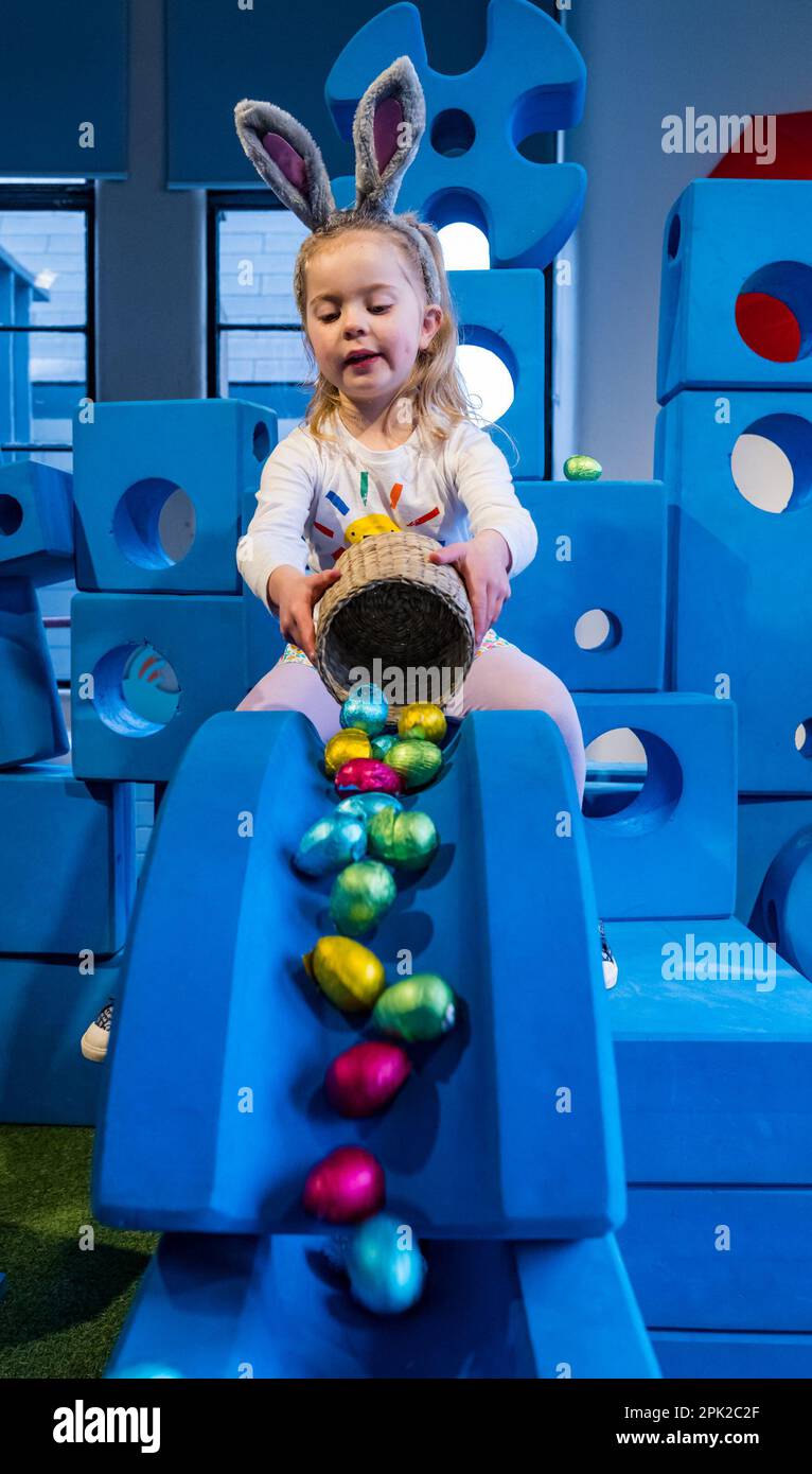 City Art Centre, Edinburgh, Scotland, UK, 05 April 2023. Edinburgh Science Festival: Children get ready for Easter by rolling colourful Easter eggs down a slide constructed from building blocks from the Imagination Playground installation. The City Art Centre has five floors of hands-on science workshops and activities and is the Festival’s premier family venue, offering all-day educational fun for children between 3 and 12 years of age. Pictured: Dorothy, aged 4 years experiments with Easter eggs and a slide. Credit: Sally Anderson/Alamy Live News Stock Photo