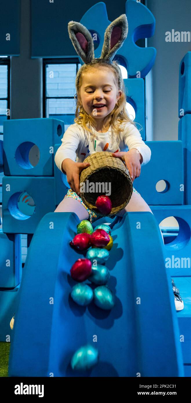 City Art Centre, Edinburgh, Scotland, UK, 05 April 2023. Edinburgh Science Festival: Children get ready for Easter by rolling colourful Easter eggs down a slide constructed from building blocks from the Imagination Playground installation. The City Art Centre has five floors of hands-on science workshops and activities and is the Festival’s premier family venue, offering all-day educational fun for children between 3 and 12 years of age. Pictured: Dorothy, aged 4 years experiments with Easter eggs and a slide. Credit: Sally Anderson/Alamy Live News Stock Photo